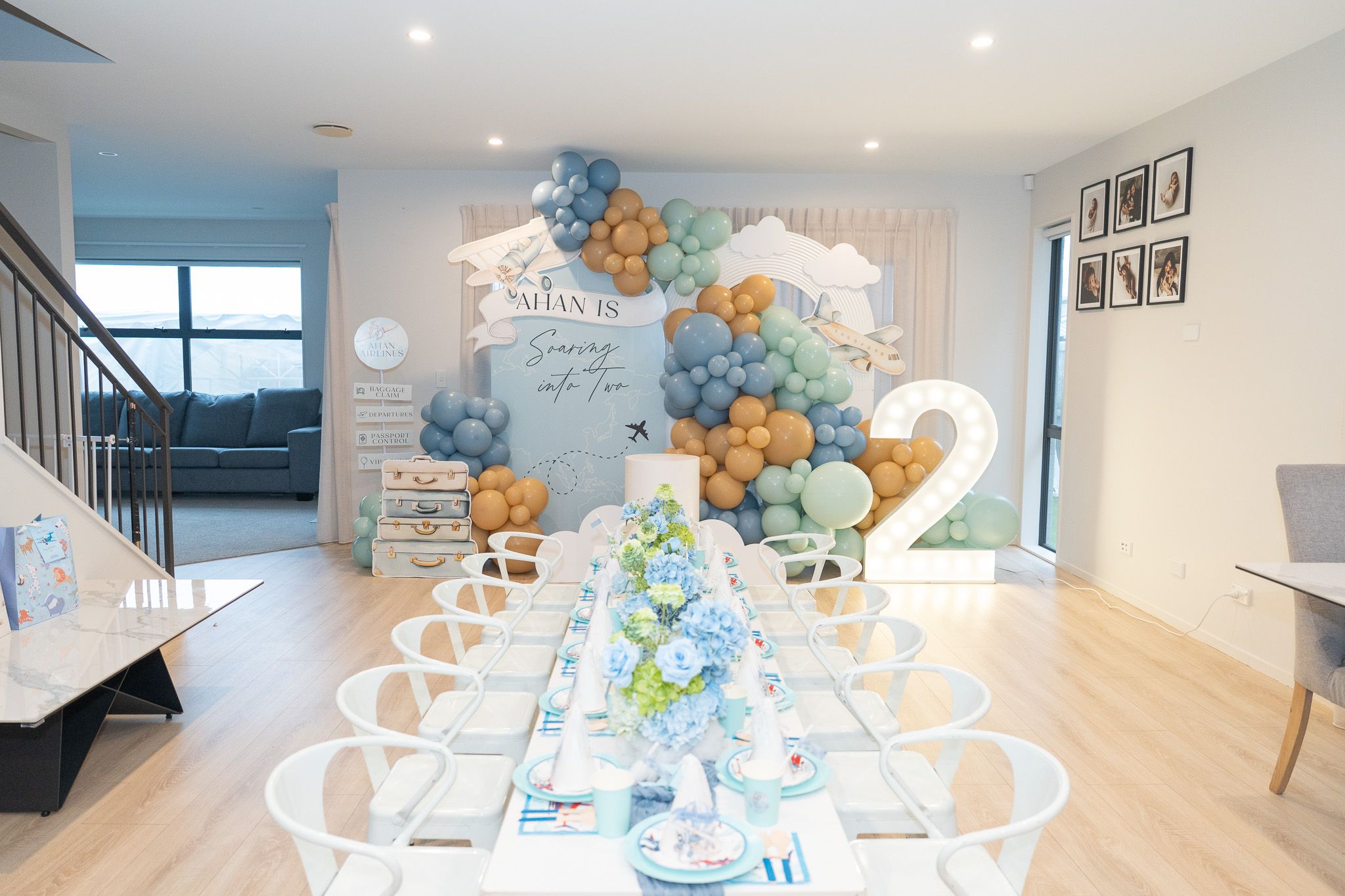 Wide view of Ahan’s airplane-themed birthday party in Auckland with balloon garland, kids table and glowing number two
