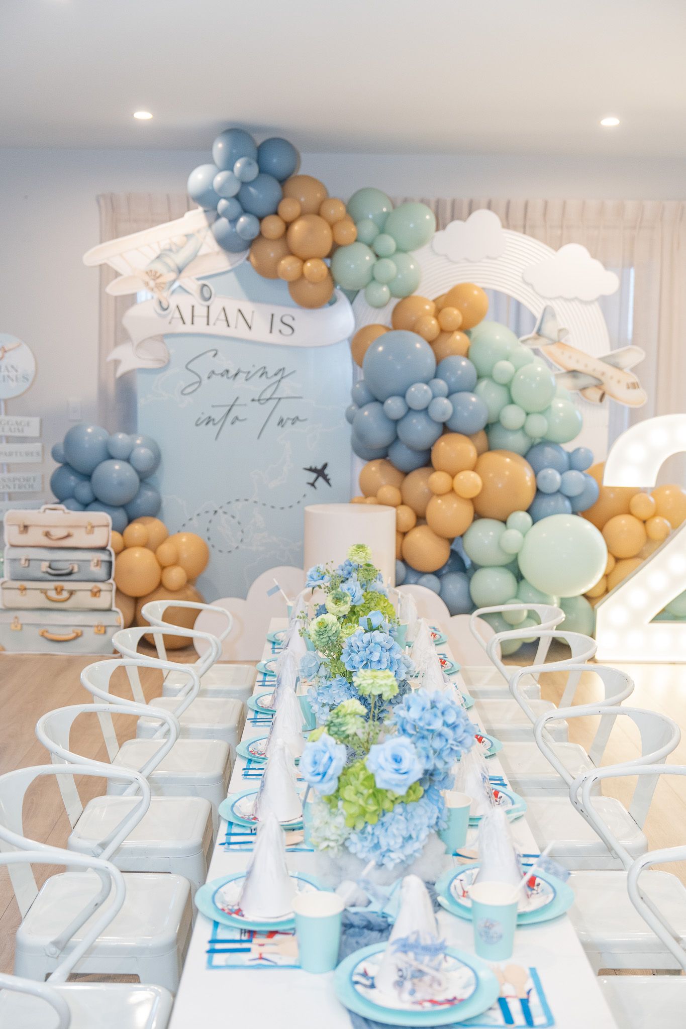 Ahan’s second birthday party setup with pastel travel theme balloons, kids table styling and airplane decor birthday photography in Auckland
