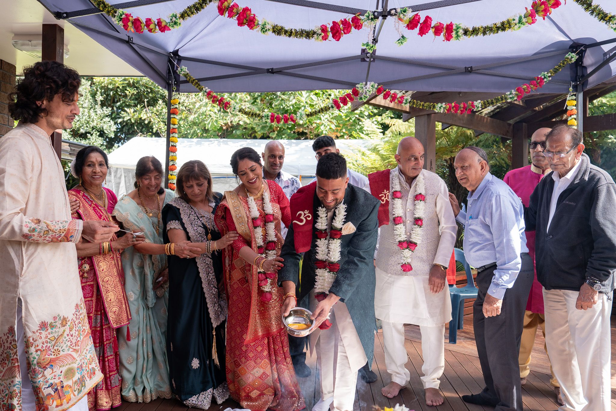 Family gathered around groom during Indian pre wedding Shantak ceremony with traditional rituals captured during wedding photography in Auckland