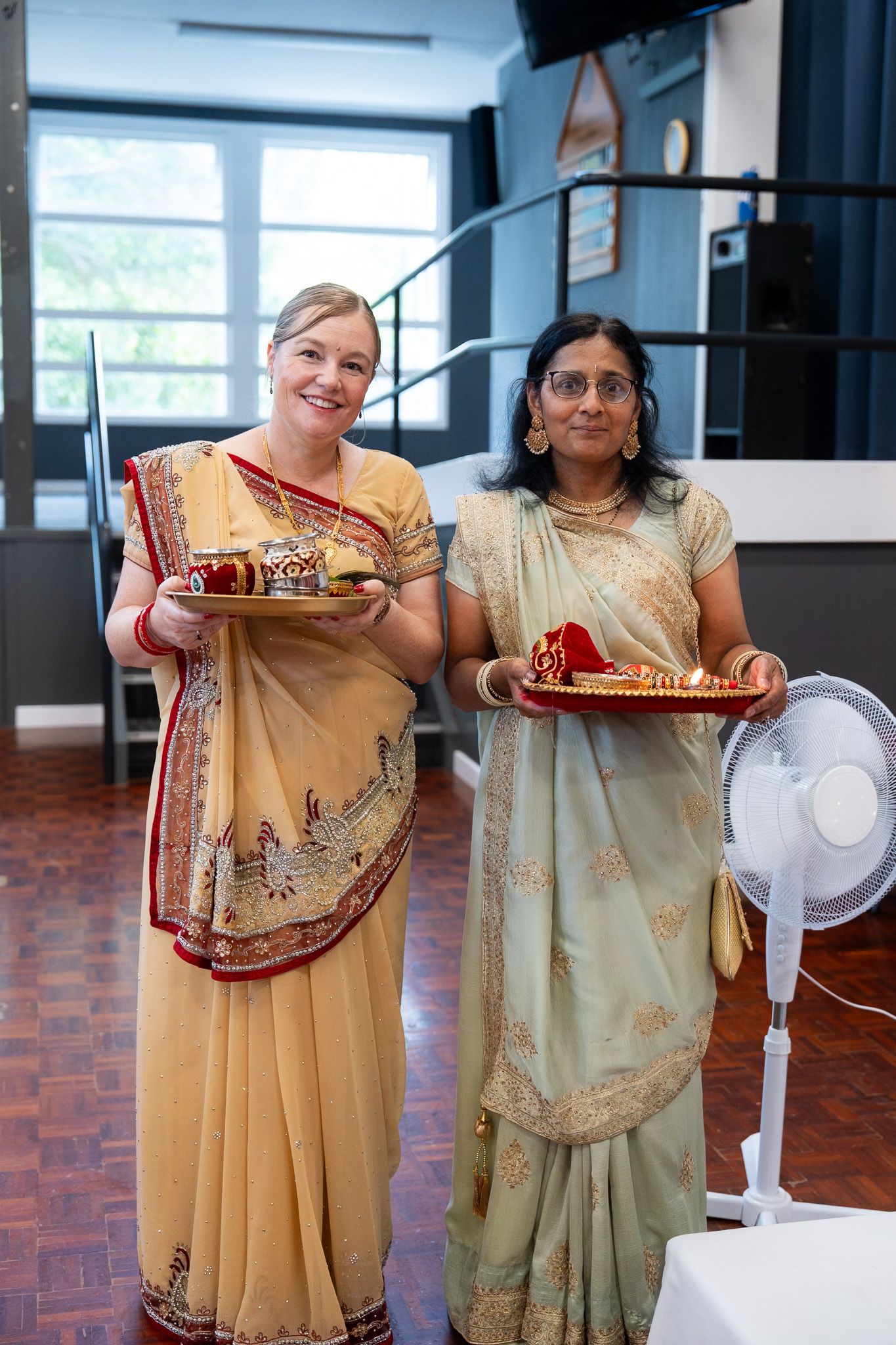 Guests holding ceremonial trays during Indian pre wedding Shantak event captured in cultural wedding photography in Auckland