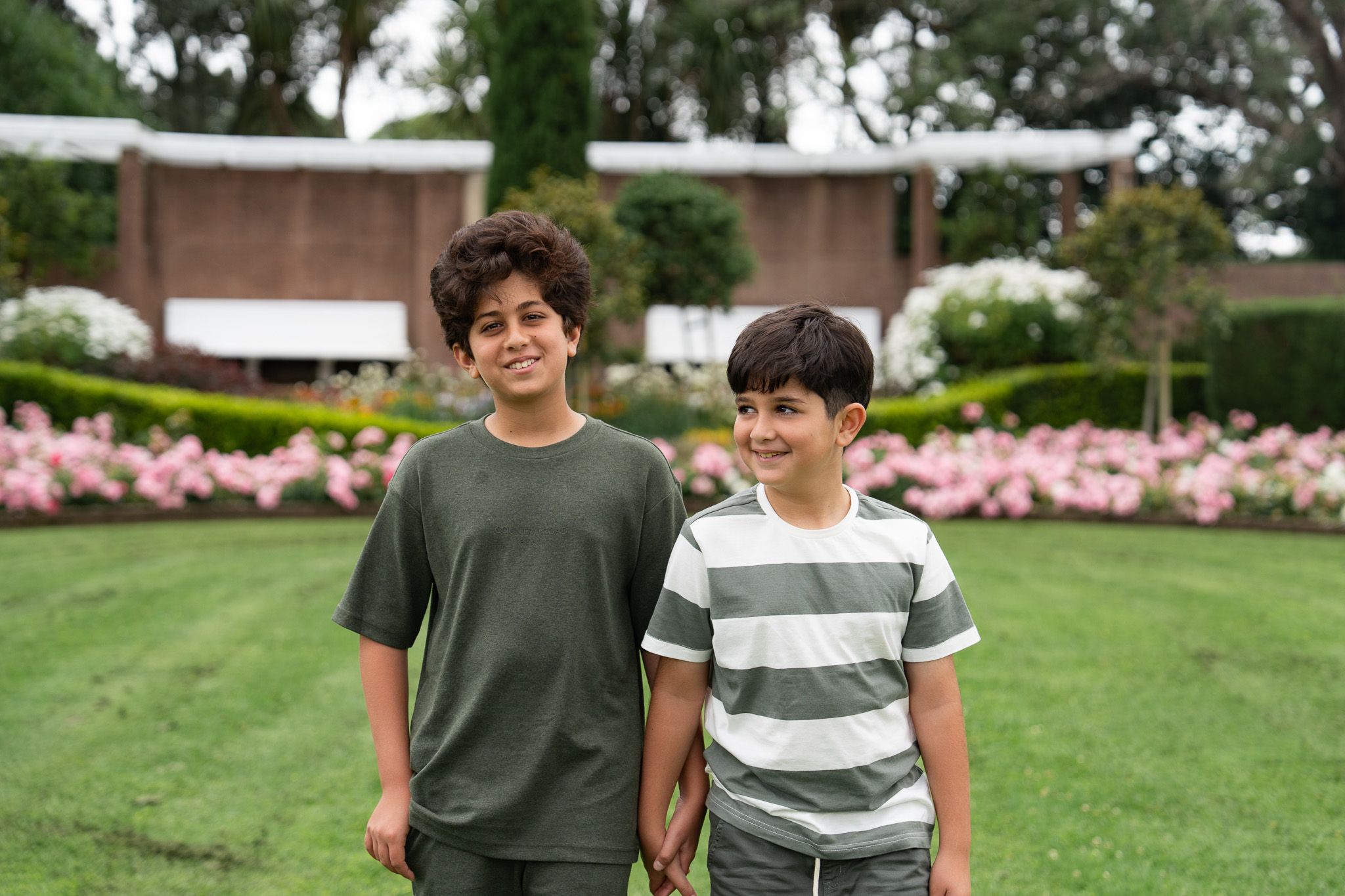 Brother portrait during a family photography session in Auckland with two boys smiling together in the gardens at Michael Joseph Savage Memorial