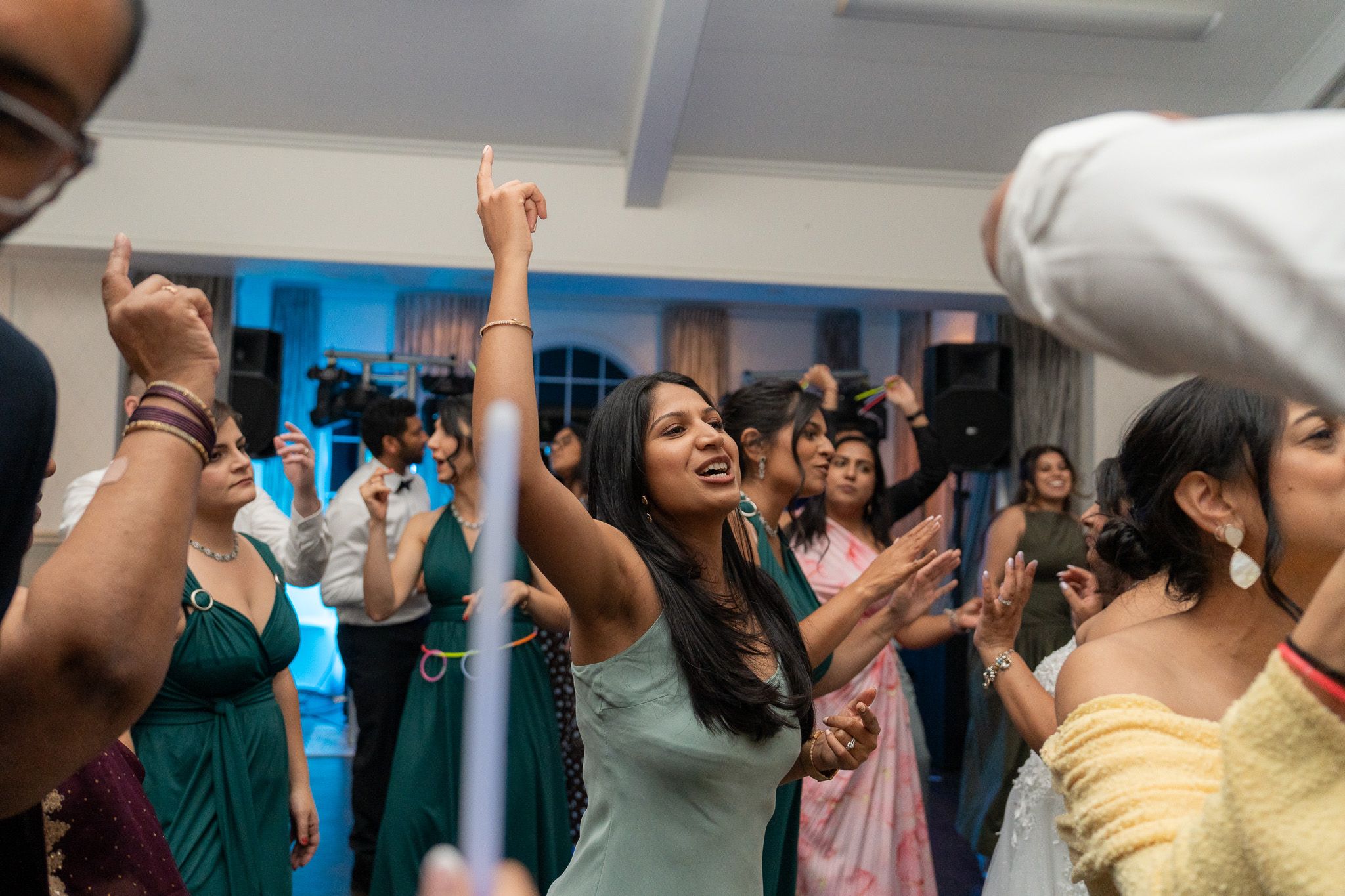 Guests dancing and celebrating on packed dance floor at Bracu Estate South Auckland Indian wedding reception photography