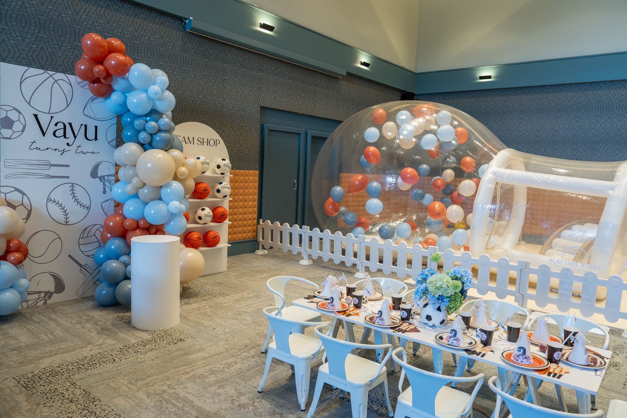 Vayu’s 2nd birthday party setup with balloon garland, kids’ table and inflatable play area at Naumi Hotel Auckland Airport
